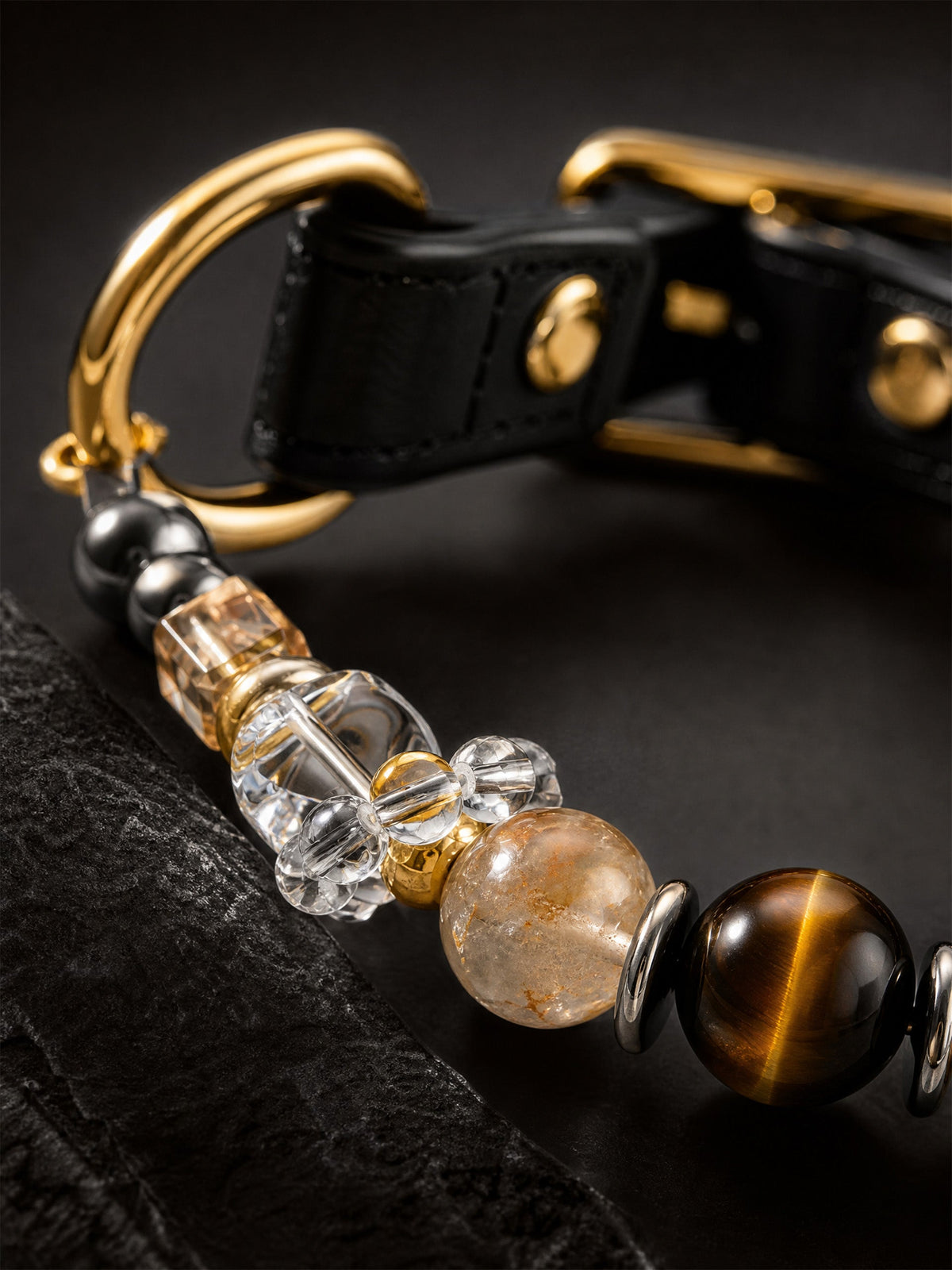 Close-up of a SoulBond crystal pet collar with black strap and gold-tone hardware