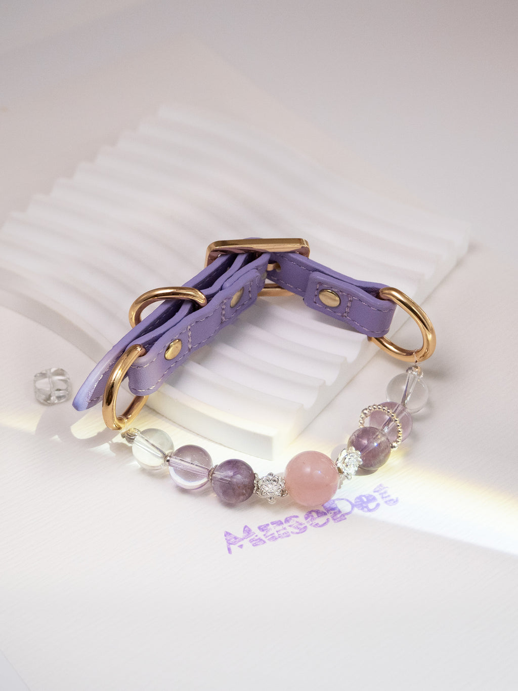 SoulBond Princess Crystal Cat Collar displayed on a white ridged stand with pink, purple and clear beads