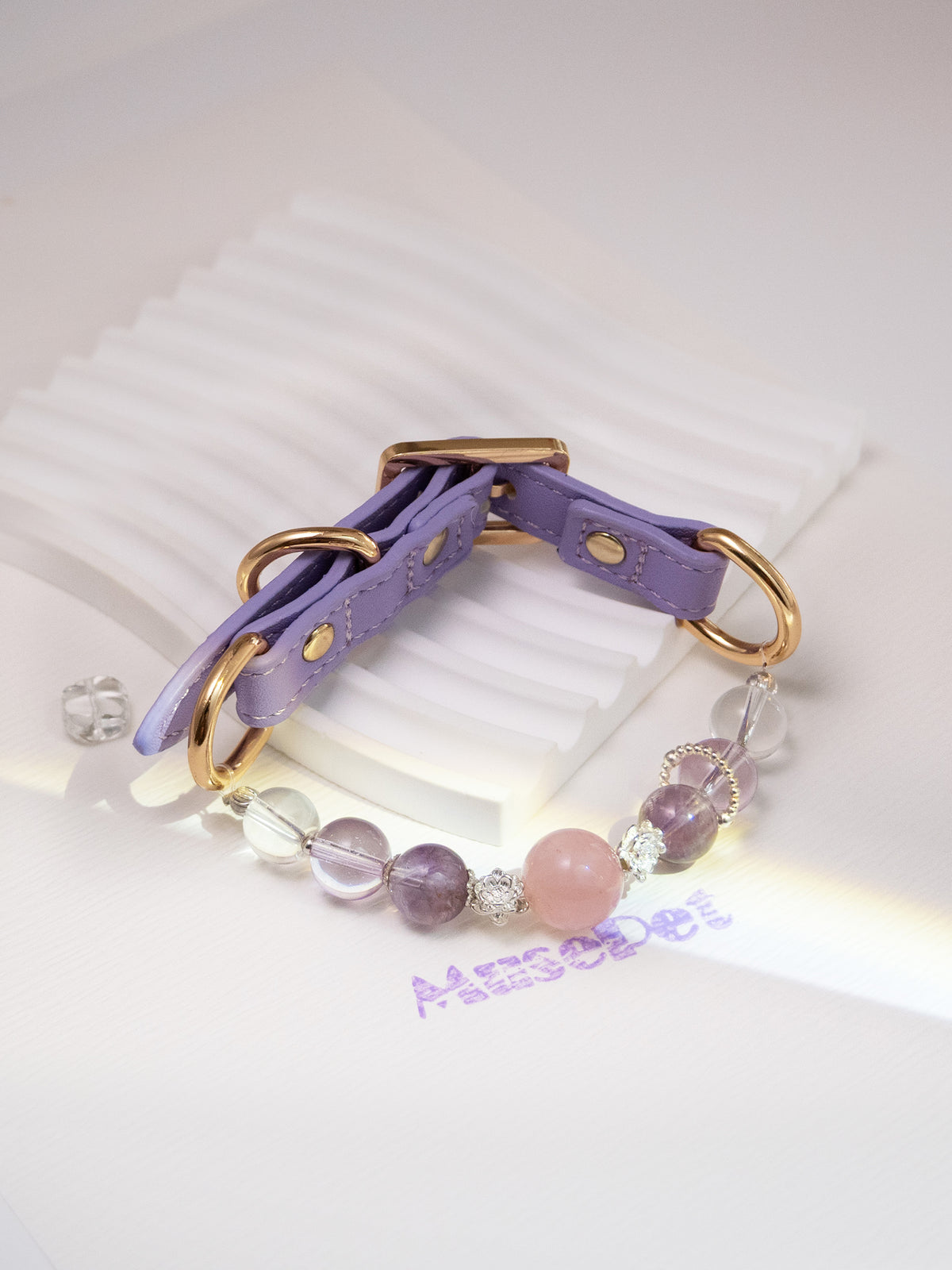 SoulBond Princess Crystal Cat Collar displayed on a white ridged stand with pink, purple and clear beads