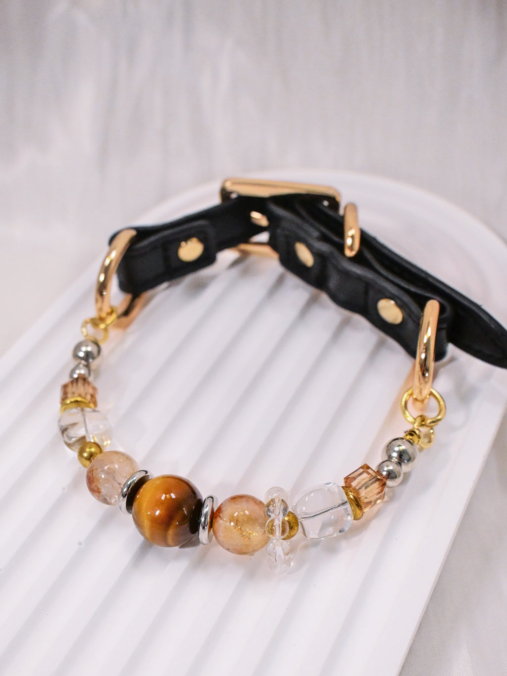SoulBond Vintage Beaded Crystal Pet Collar with brown and clear beads and a black strap on a white ridged tray