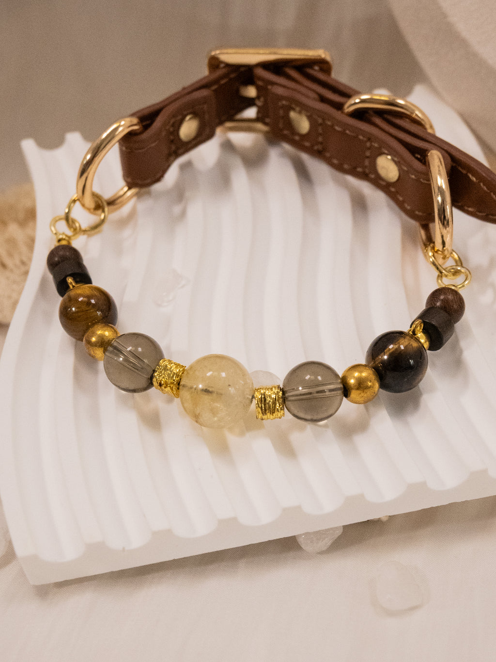 SoulBond Crystal Beaded Pet Collar with a brown strap and yellow, gray and brown beads arranged on a white display tray