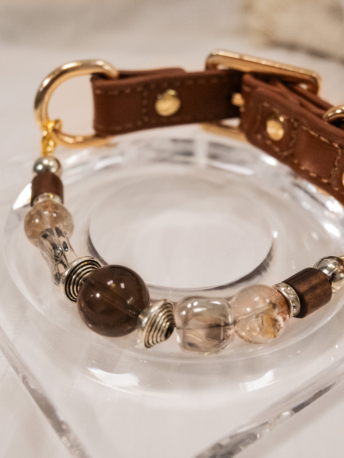 SoulBond Vintage Crystal Cat Collar close-up of brown and pale yellow beads arranged around a clear display dish