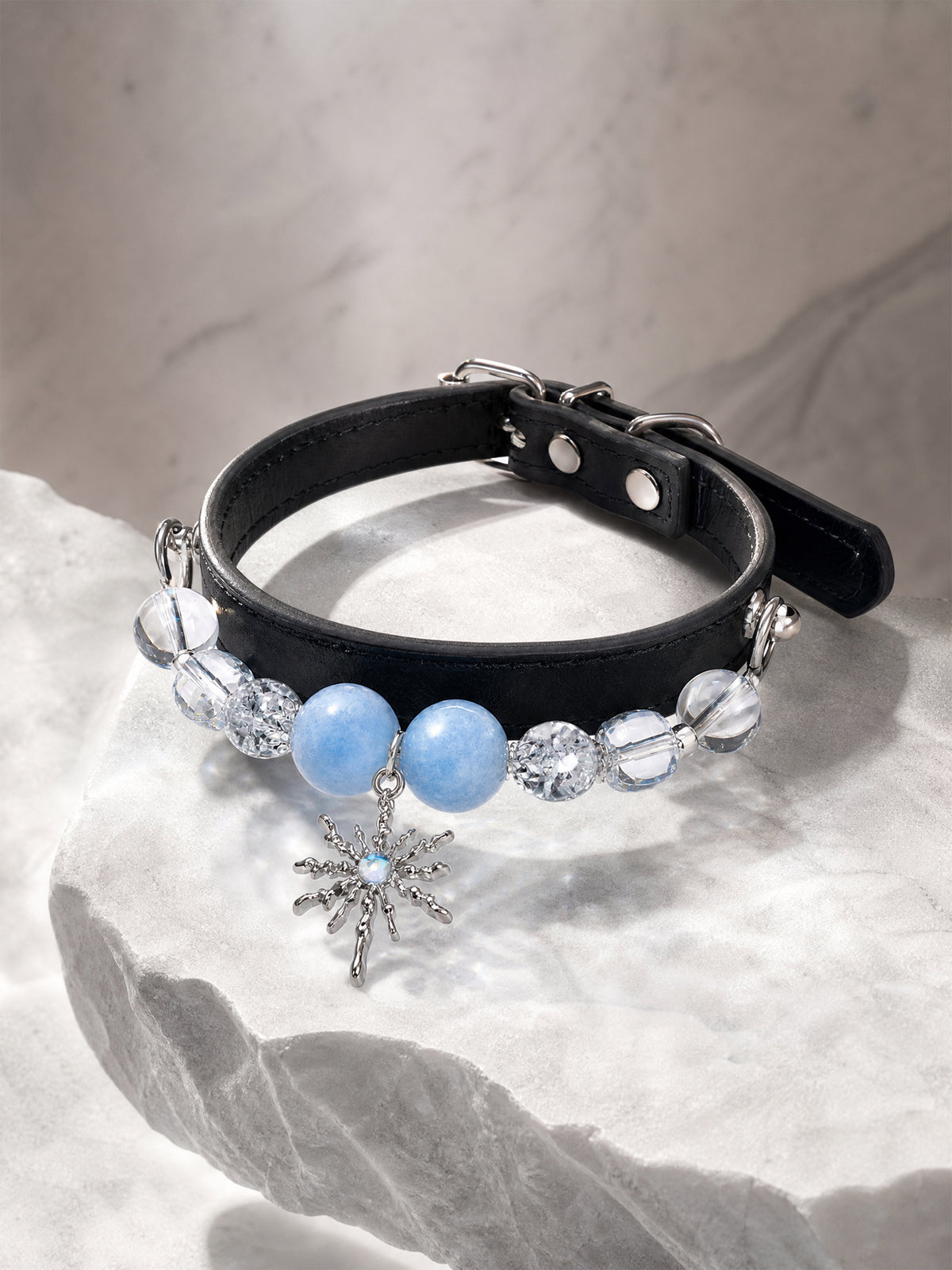 SoulBond Elegant Princess Crystal Pet Collar with blue and clear beads on a pale rough-edged display slab