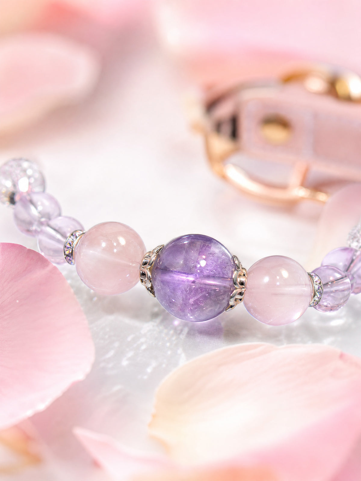 SoulBond Crystal Charm Pet Collar close-up of the purple center bead and pink beads beside pink petals
