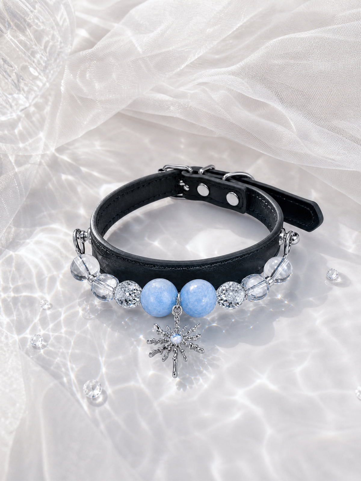 SoulBond Elegant Princess Crystal Pet Collar with blue beads and a starburst charm displayed beside sheer white fabric