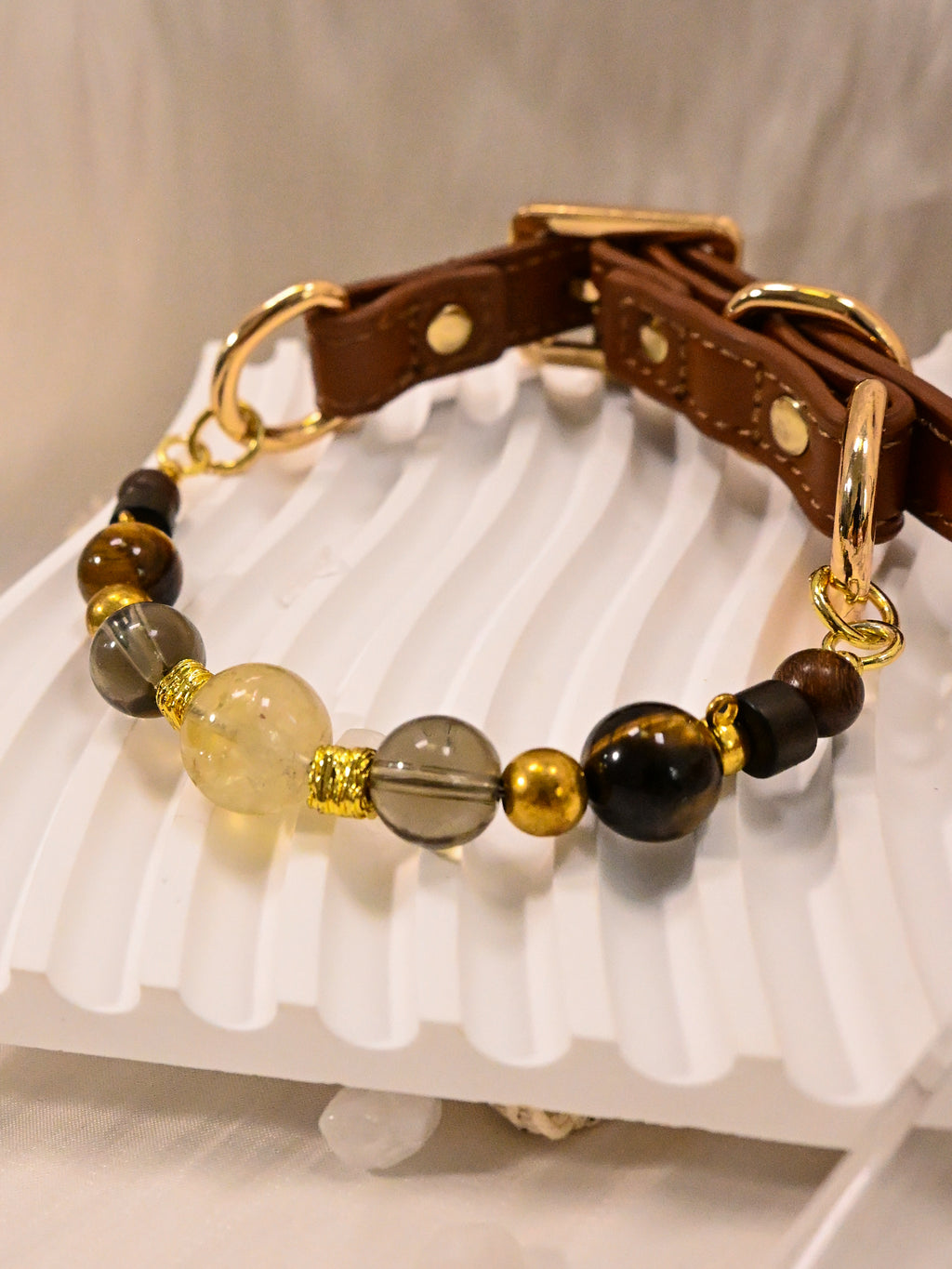 SoulBond Crystal Beaded Pet Collar angled view showing brown striped beads and gold-tone rings connecting to the brown strap